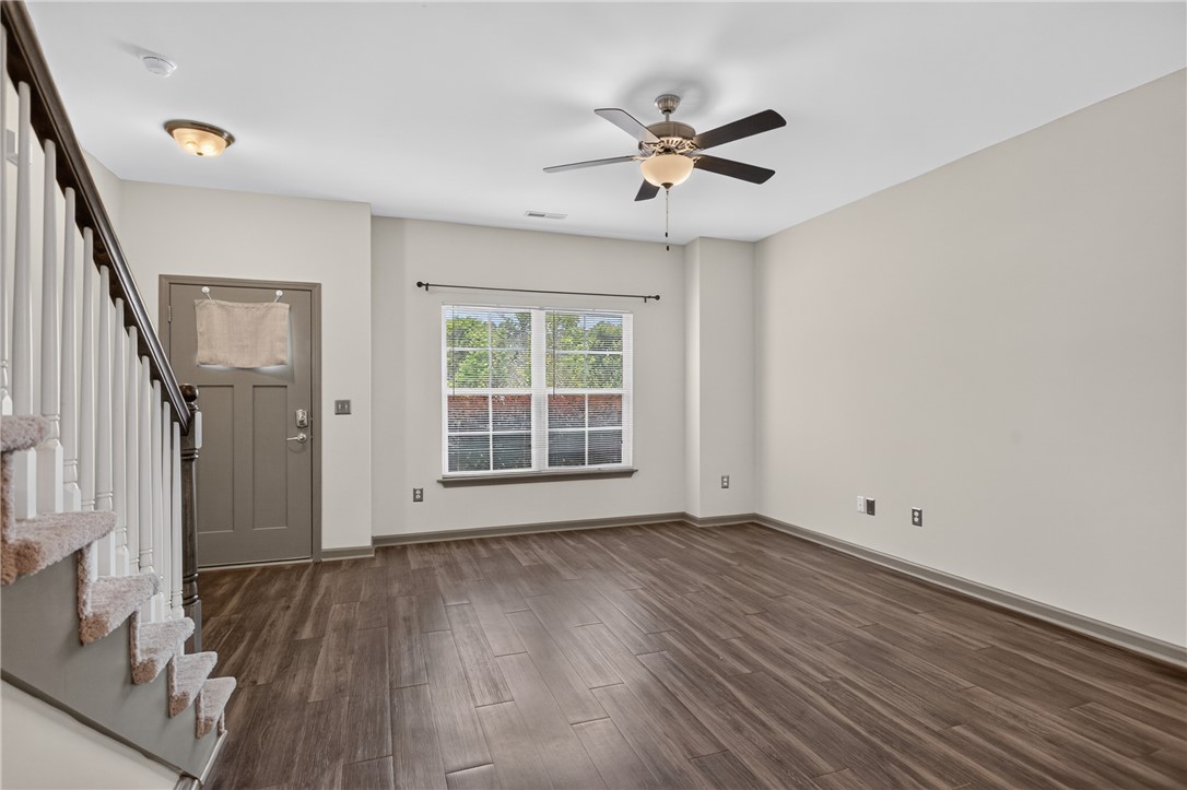 235 Pendleton Road, Unit K1 Clemson, SC 29631 - Photo 11 of 49 Rich hardwood-style flooring and a refreshing ceiling fan elevate this inviting living space.