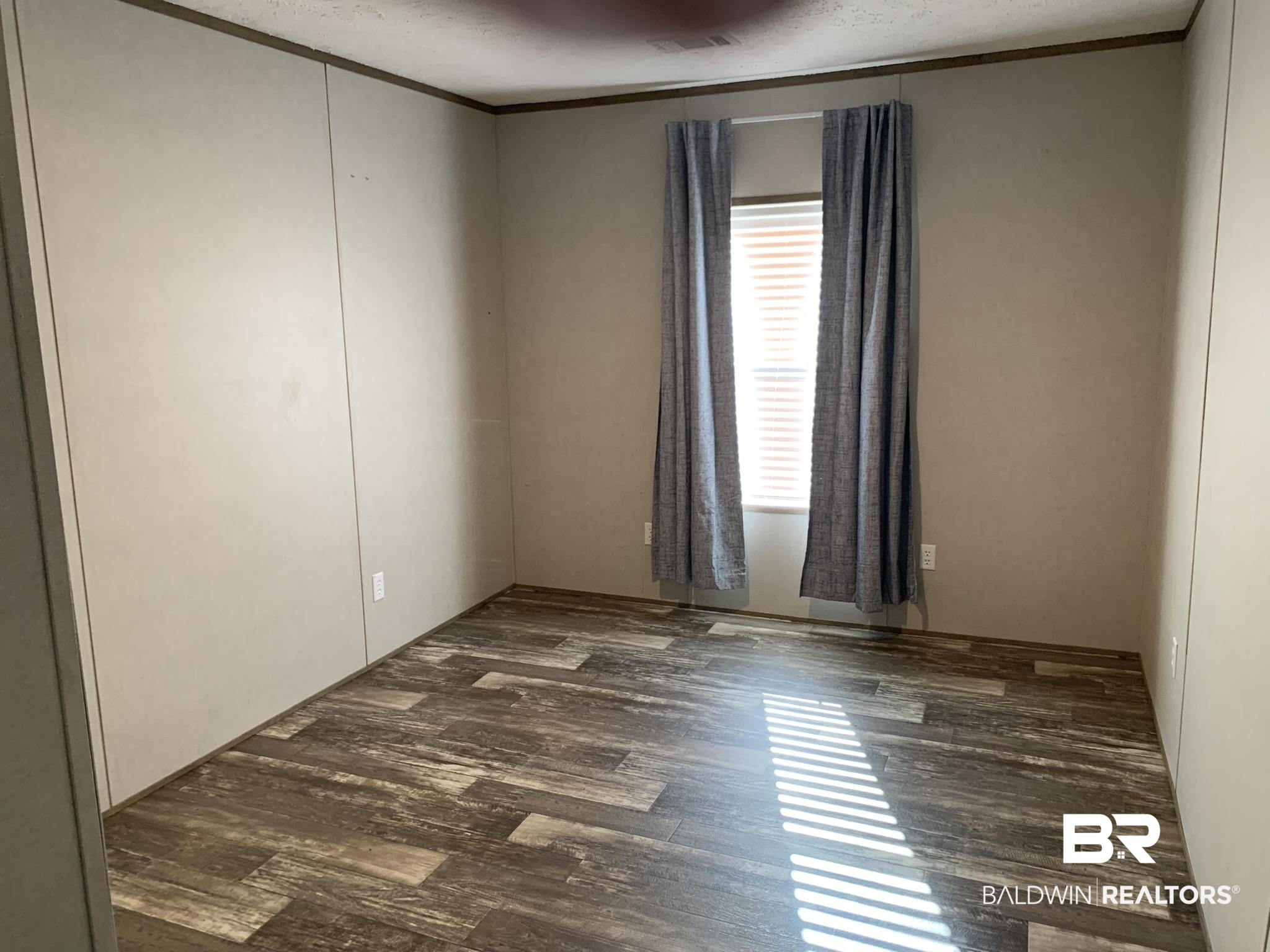 16876 County Road 87 Elberta, AL 36530 - Photo 9 of 13 Spare room featuring crown molding and dark hardwood / wood-style flooring