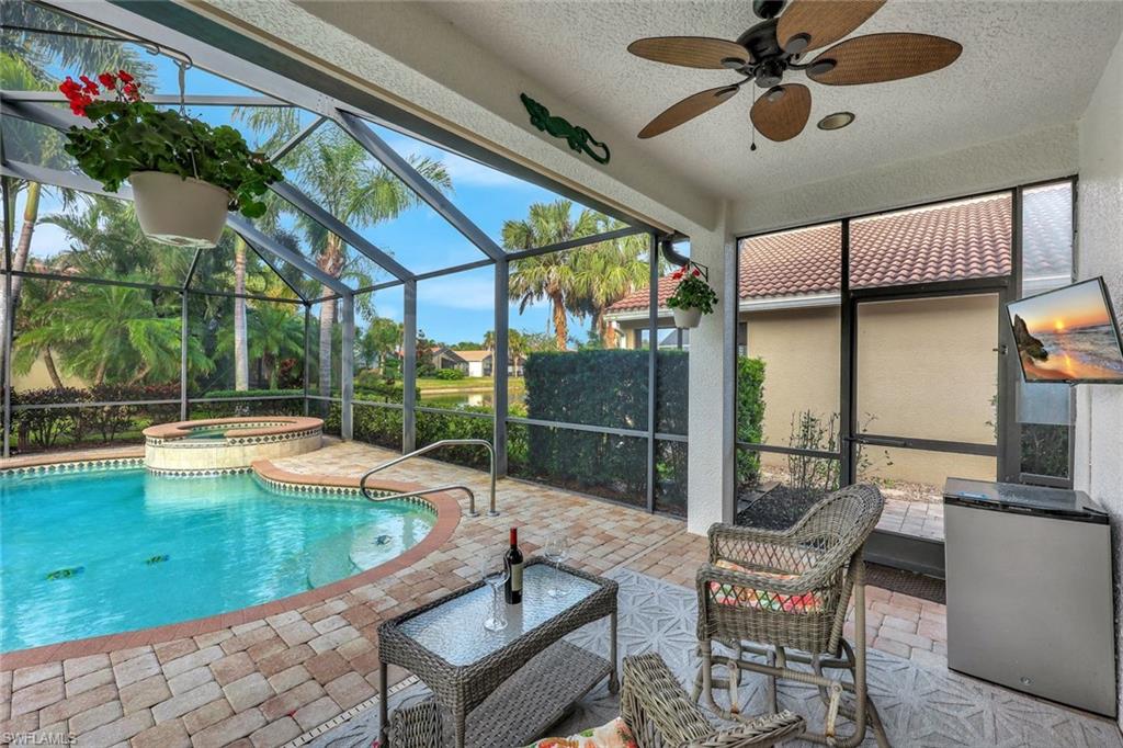 1614 Triangle Palm Terrace Naples, FL 34119 - Photo 21 of 40 a view of a swimming pool with a patio