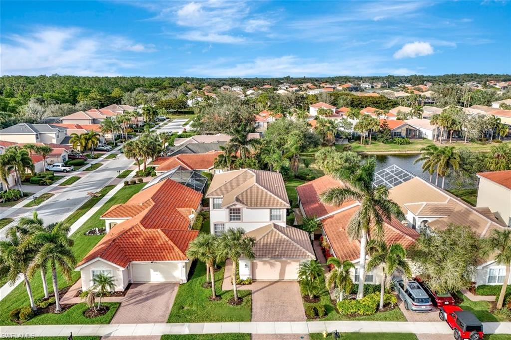 1614 Triangle Palm Terrace Naples, FL 34119 - Photo 25 of 40 a view of a city with lots of residential buildings ocean and mountain view in back