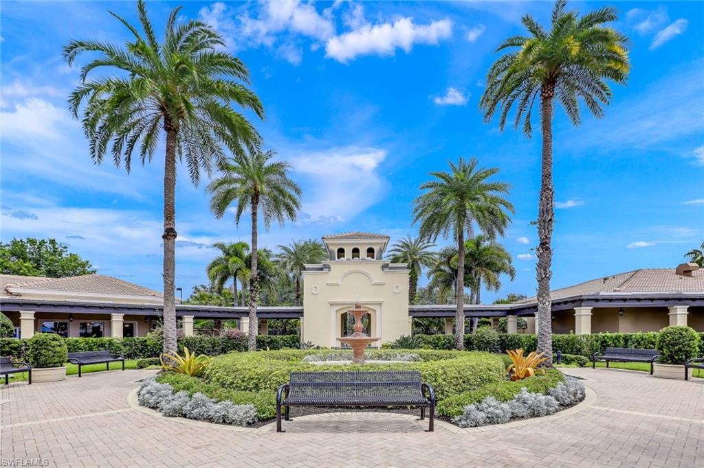 1614 Triangle Palm Terrace Naples, FL 34119 - Photo 27 of 40 front view of a house with a yard and potted plants