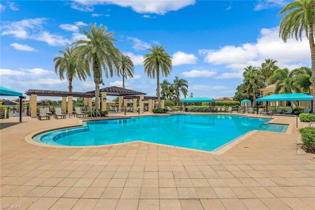 1614 Triangle Palm Terrace Naples, FL 34119 - Photo 28 of 40 a view of a swimming pool and a yard