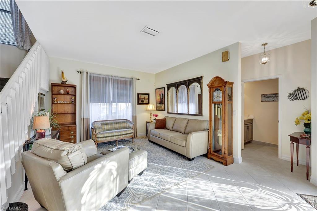 1614 Triangle Palm Terrace Naples, FL 34119 - Photo 3 of 40 a bedroom with furniture and a rug