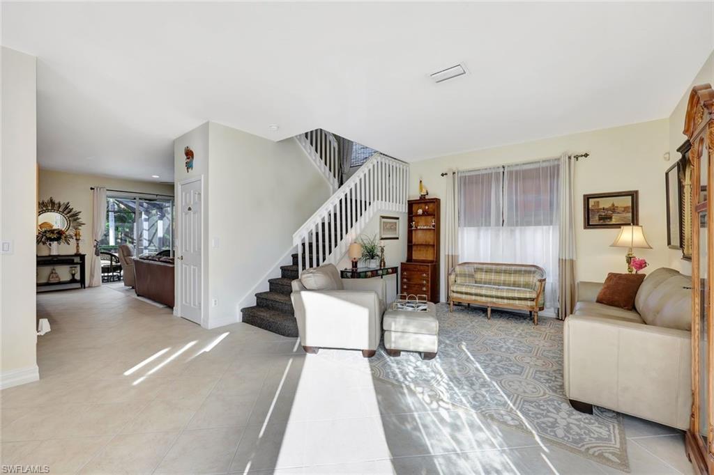 1614 Triangle Palm Terrace Naples, FL 34119 - Photo 4 of 40 a living room with furniture and a wooden floor