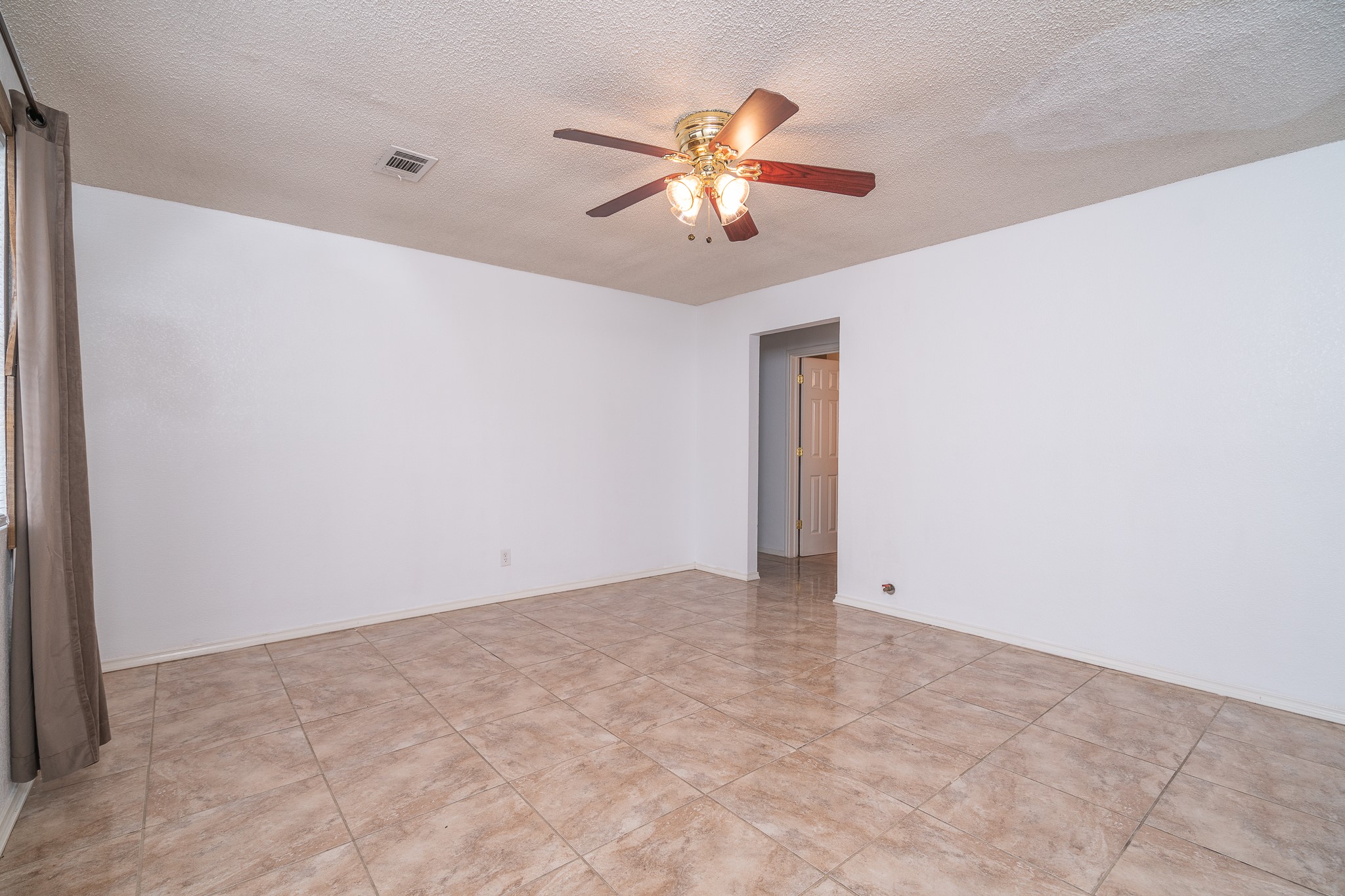 3409 Herbert Pearland, TX 77584 - Photo 12 of 17 a view of an empty room with chandelier fan and a ceiling fan