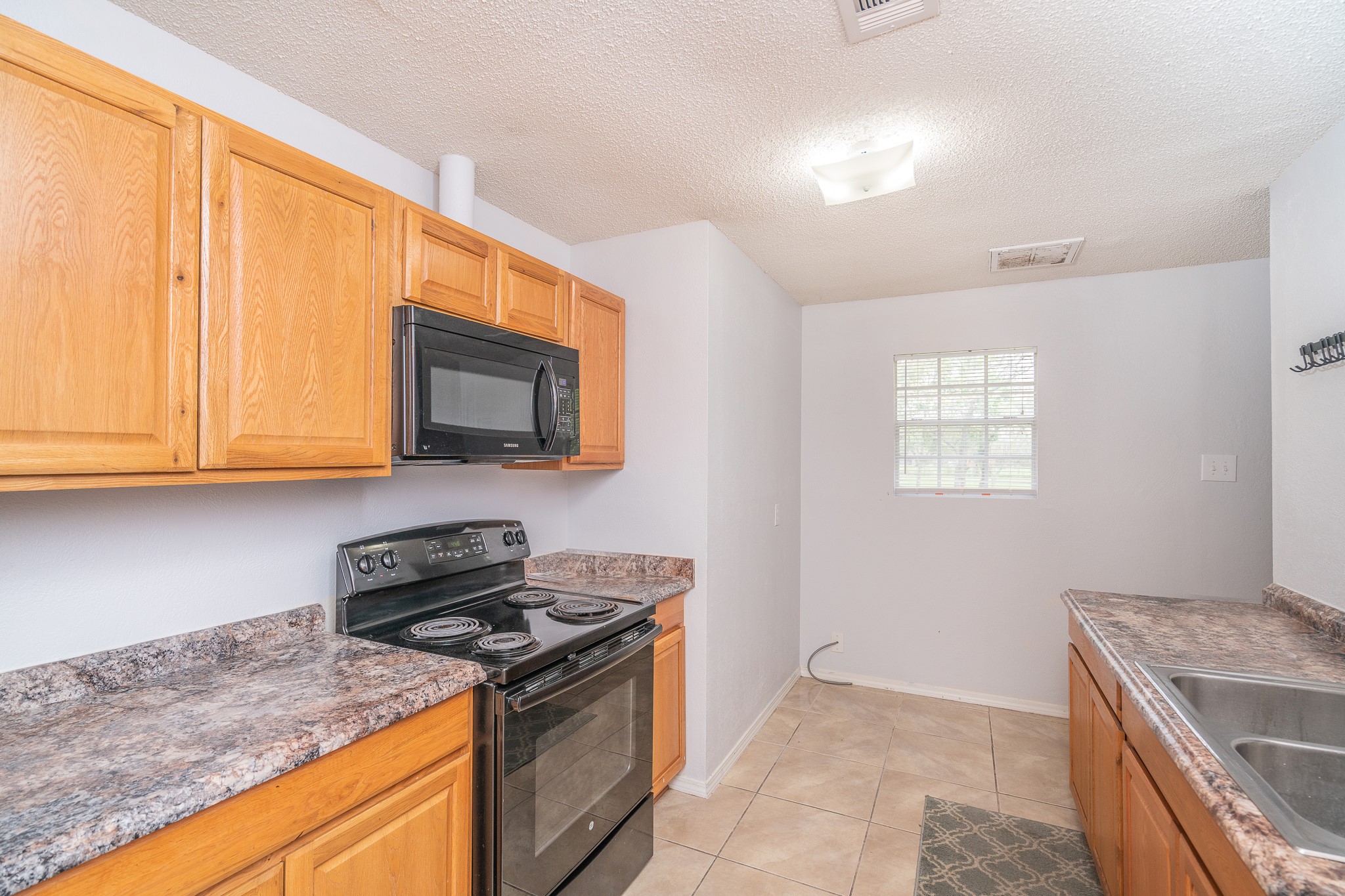 3409 Herbert Pearland, TX 77584 - Photo 6 of 17 a kitchen with a stove and a microwave