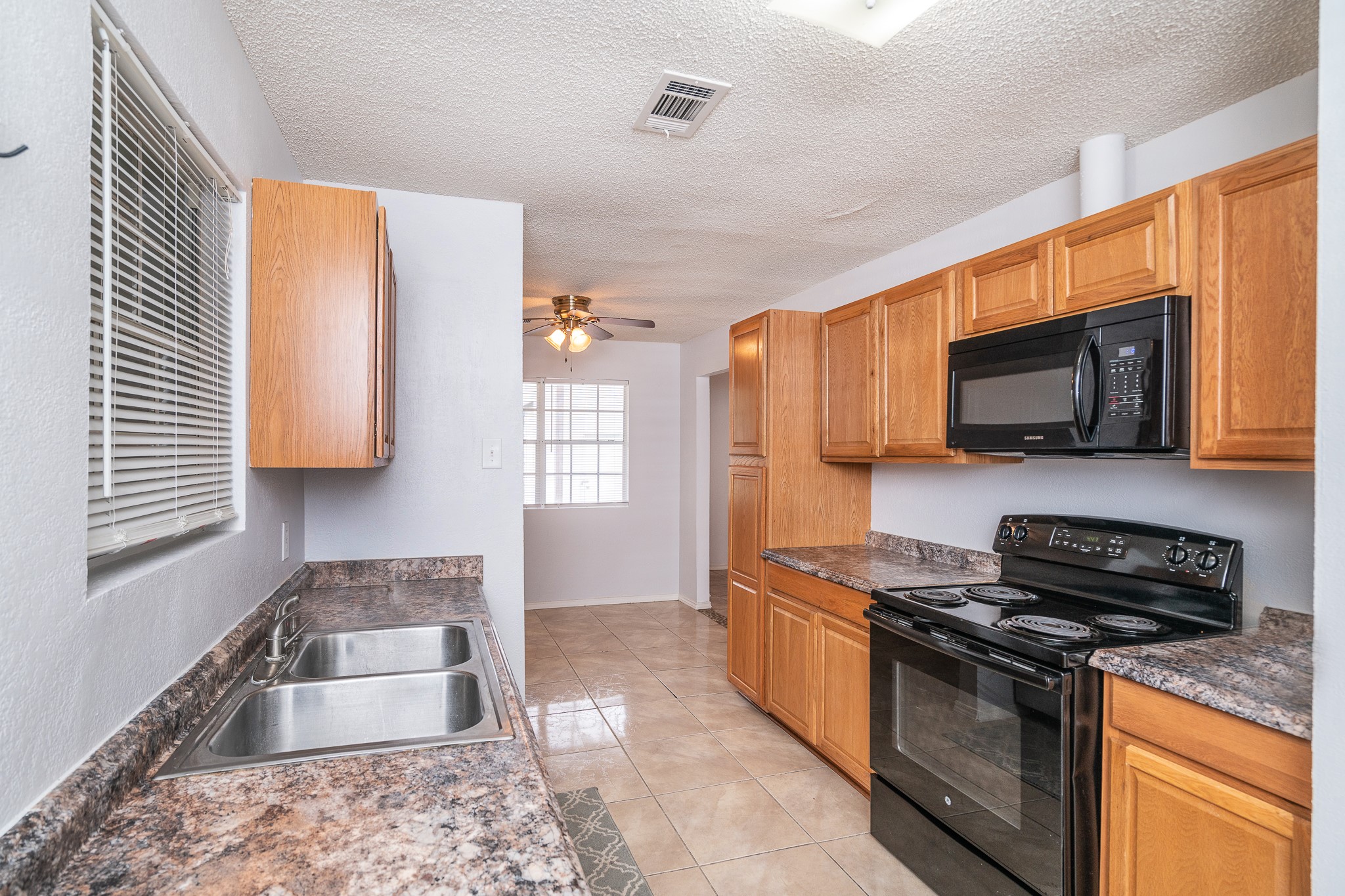 3409 Herbert Pearland, TX 77584 - Photo 8 of 17 a kitchen with stainless steel appliances granite countertop a stove a sink and a microwave