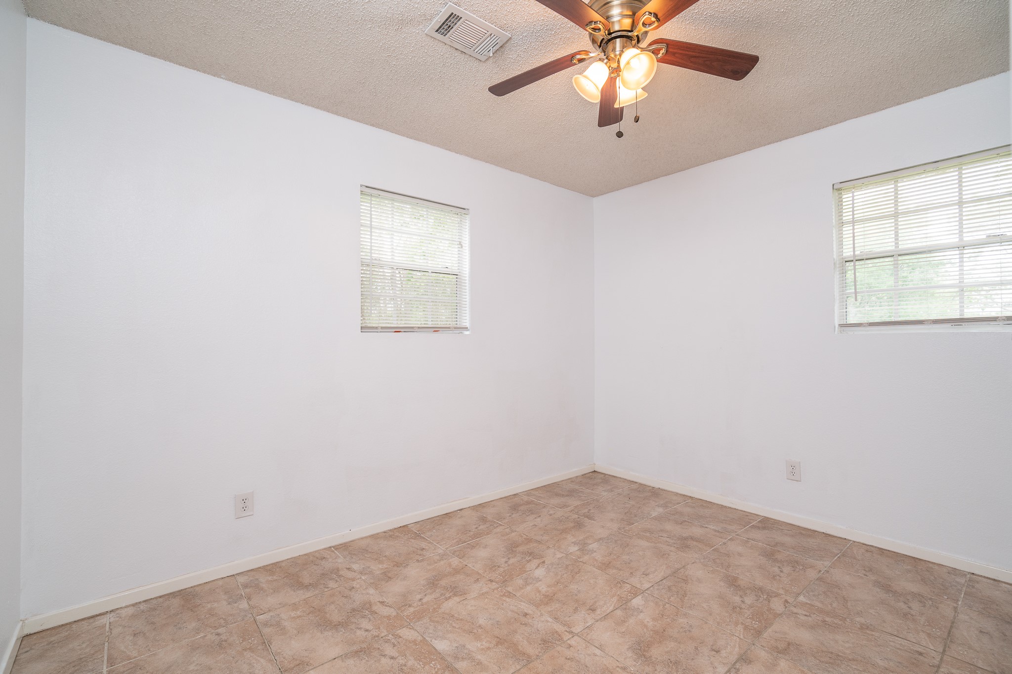 3409 Herbert Pearland, TX 77584 - Photo 10 of 17 an empty room with windows and fan