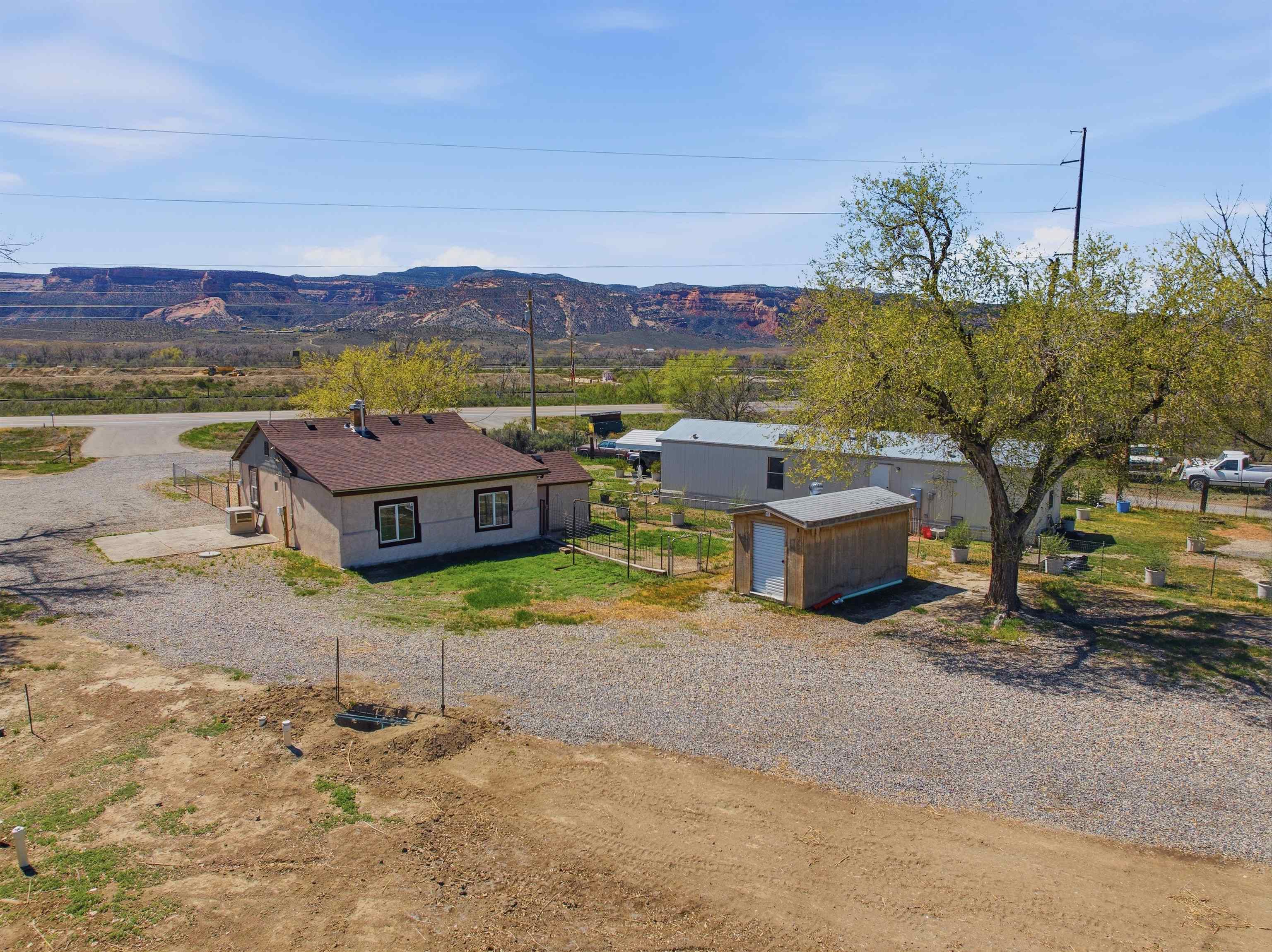 333 Highway 6 And 50 Fruita, CO 81521 - Photo 23 of 36 a view of a house with a mountain and a yard