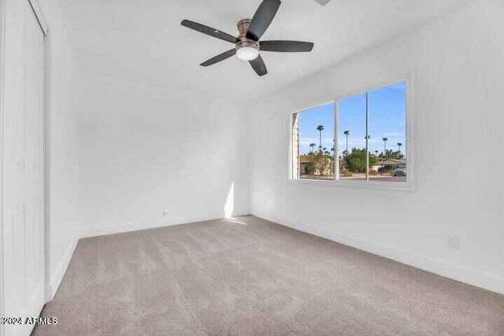 1734 East Laguna Drive Tempe, AZ 85282 - Photo 14 of 23 an empty room with a window and a ceiling fan