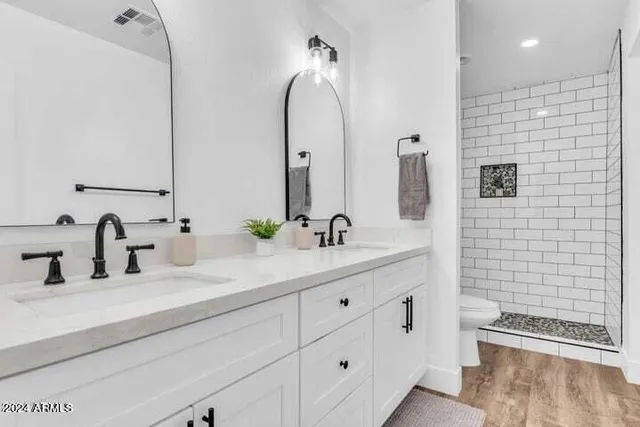 a bathroom with a double vanity sink and a mirror