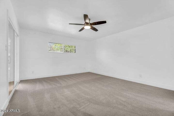 1734 East Laguna Drive Tempe, AZ 85282 - Photo 19 of 23 an empty room with a ceiling fan and window