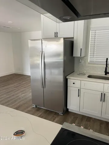 a kitchen with stainless steel appliances a refrigerator sink and cabinets