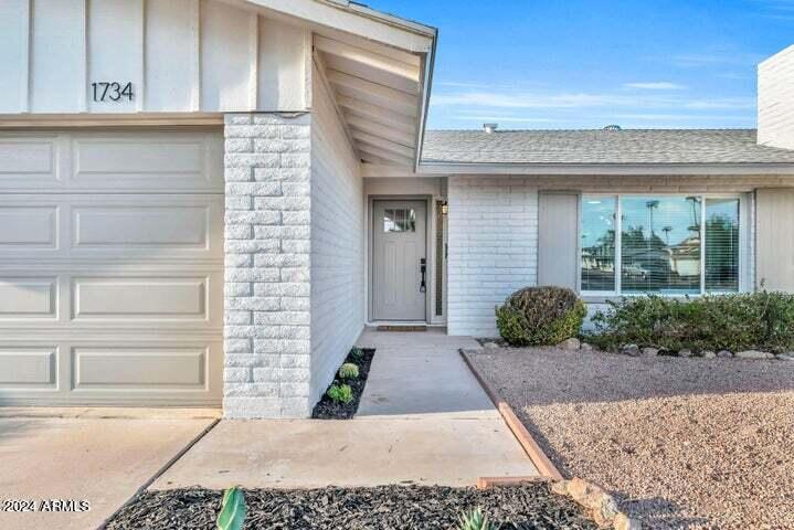 1734 East Laguna Drive Tempe, AZ 85282 - Photo 3 of 23 a front view of a house with a garden