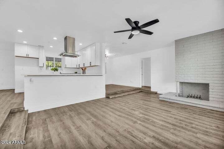 1734 East Laguna Drive Tempe, AZ 85282 - Photo 9 of 23 a kitchen with stainless steel appliances kitchen island a refrigerator sink and white cabinets