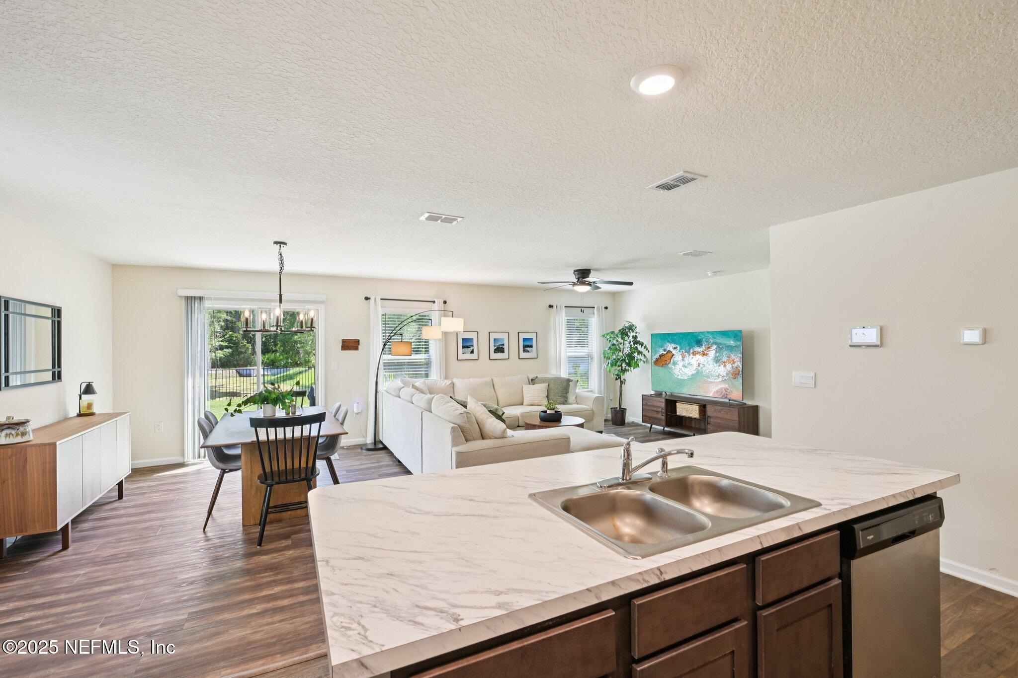 1143 Morgans Treasure Road St. Augustine, FL 32084 - Photo 14 of 39 a living room with furniture and a wooden floor
