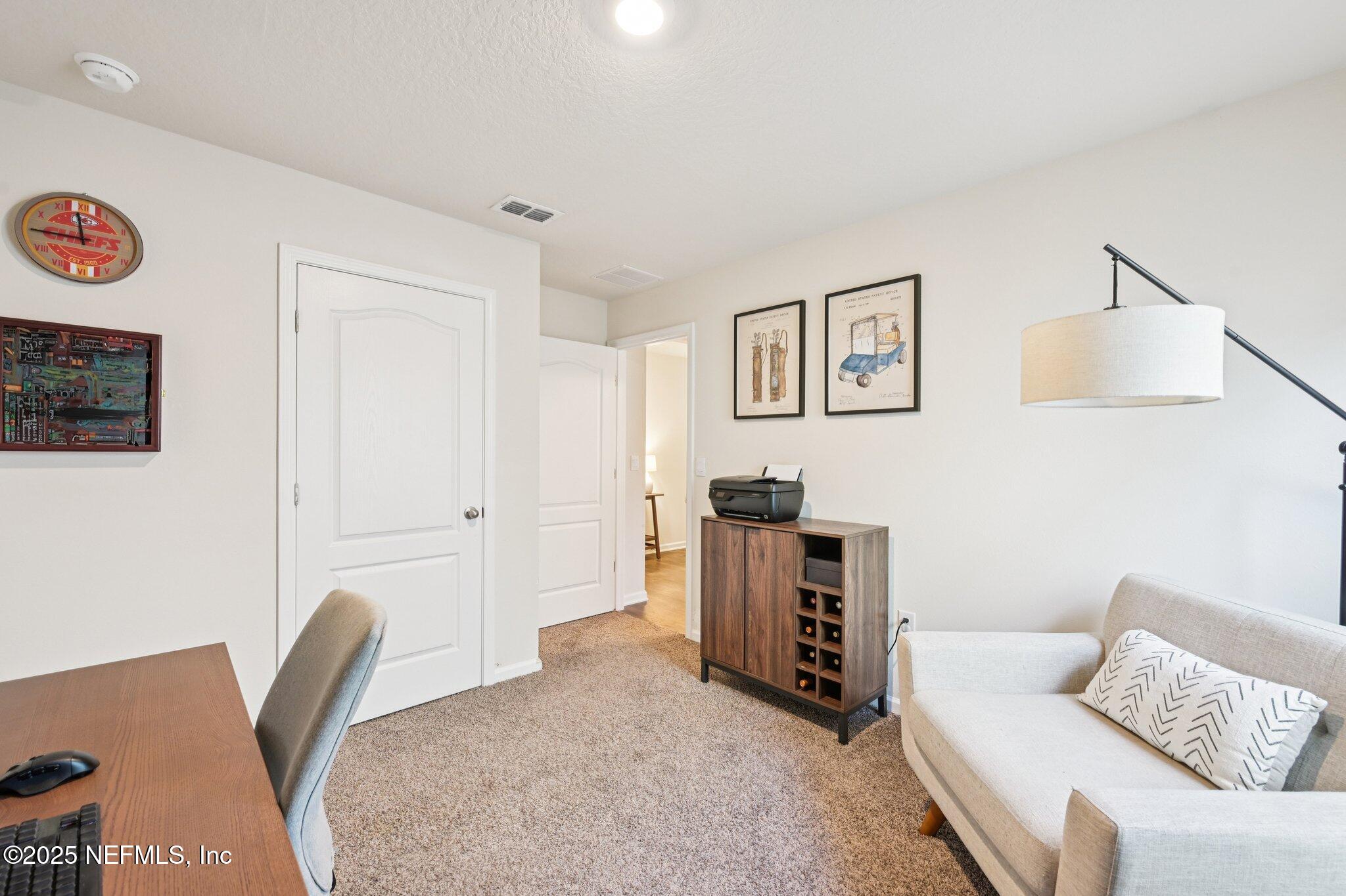 1143 Morgans Treasure Road St. Augustine, FL 32084 - Photo 18 of 39 a living room with furniture and a flat screen tv