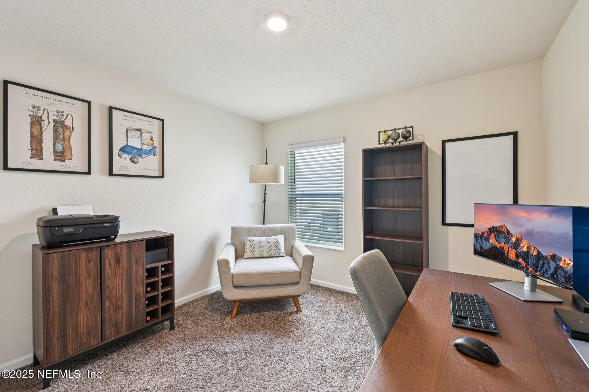 1143 Morgans Treasure Road St. Augustine, FL 32084 - Photo 19 of 39 a living room with furniture a rug and a wooden floor