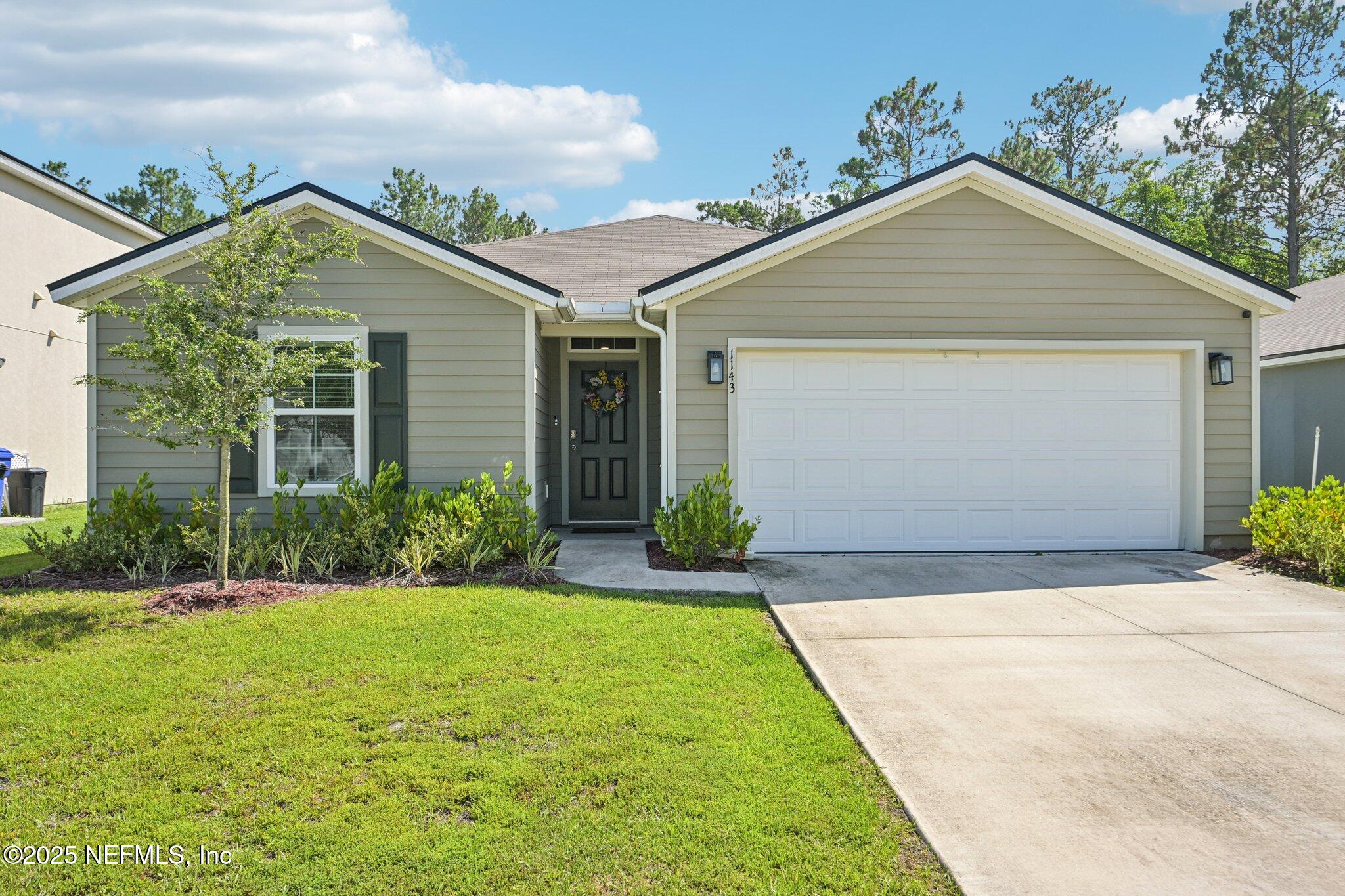 1143 Morgans Treasure Road St. Augustine, FL 32084 - Photo 2 of 39 a front view of house with yard and green space