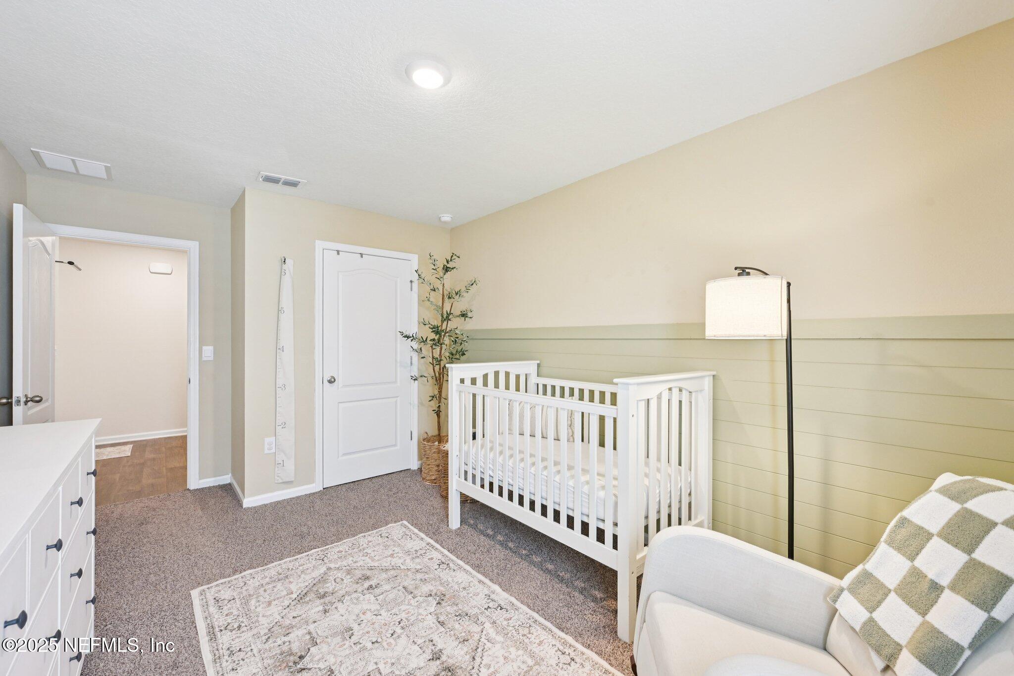 1143 Morgans Treasure Road St. Augustine, FL 32084 - Photo 25 of 39 a view of a bedroom with furniture and window