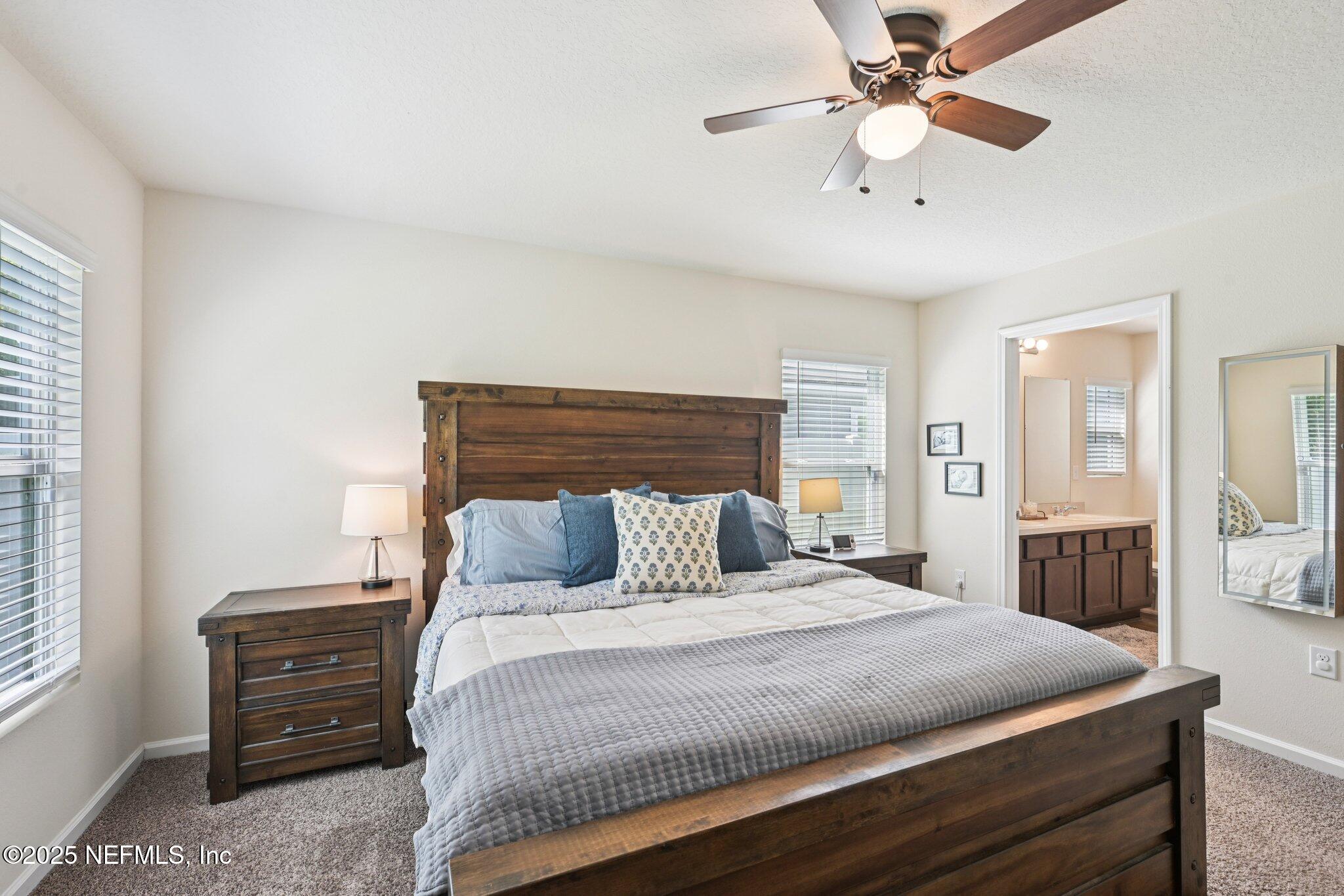 1143 Morgans Treasure Road St. Augustine, FL 32084 - Photo 27 of 39 a bedroom with a bed and a chandelier