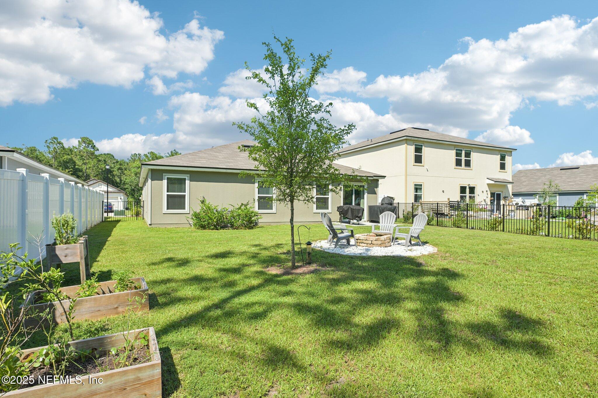 1143 Morgans Treasure Road St. Augustine, FL 32084 - Photo 33 of 39 a view of a house with backyard and sitting area