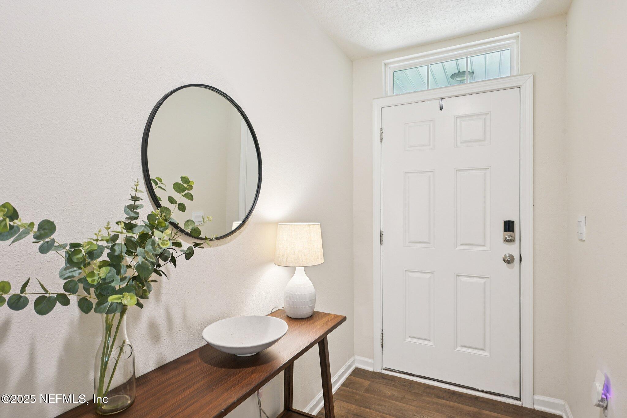 1143 Morgans Treasure Road St. Augustine, FL 32084 - Photo 4 of 39 a front view of a house with wooden floor and a potted plant