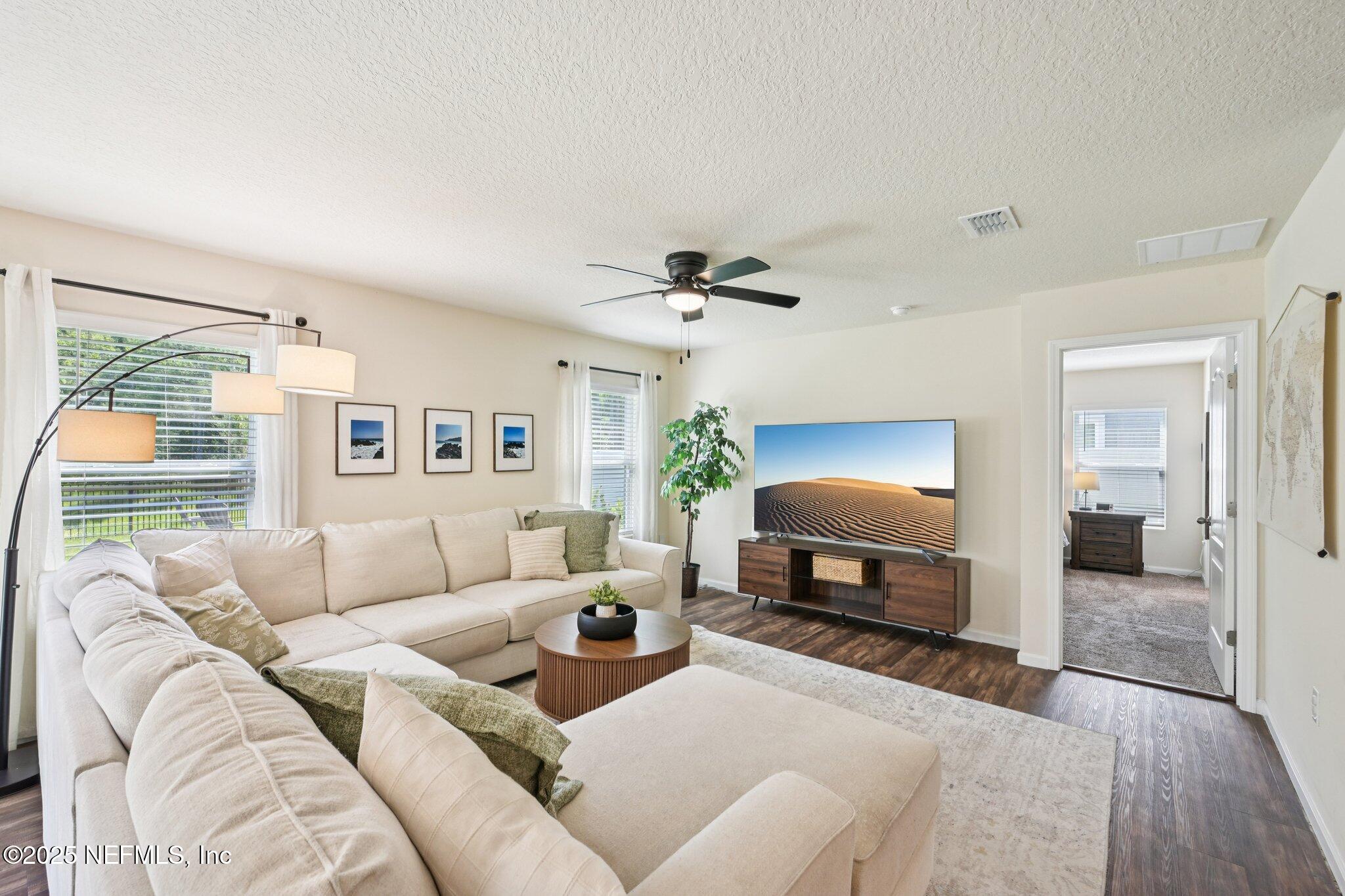 1143 Morgans Treasure Road St. Augustine, FL 32084 - Photo 5 of 39 a living room with furniture and a lamp