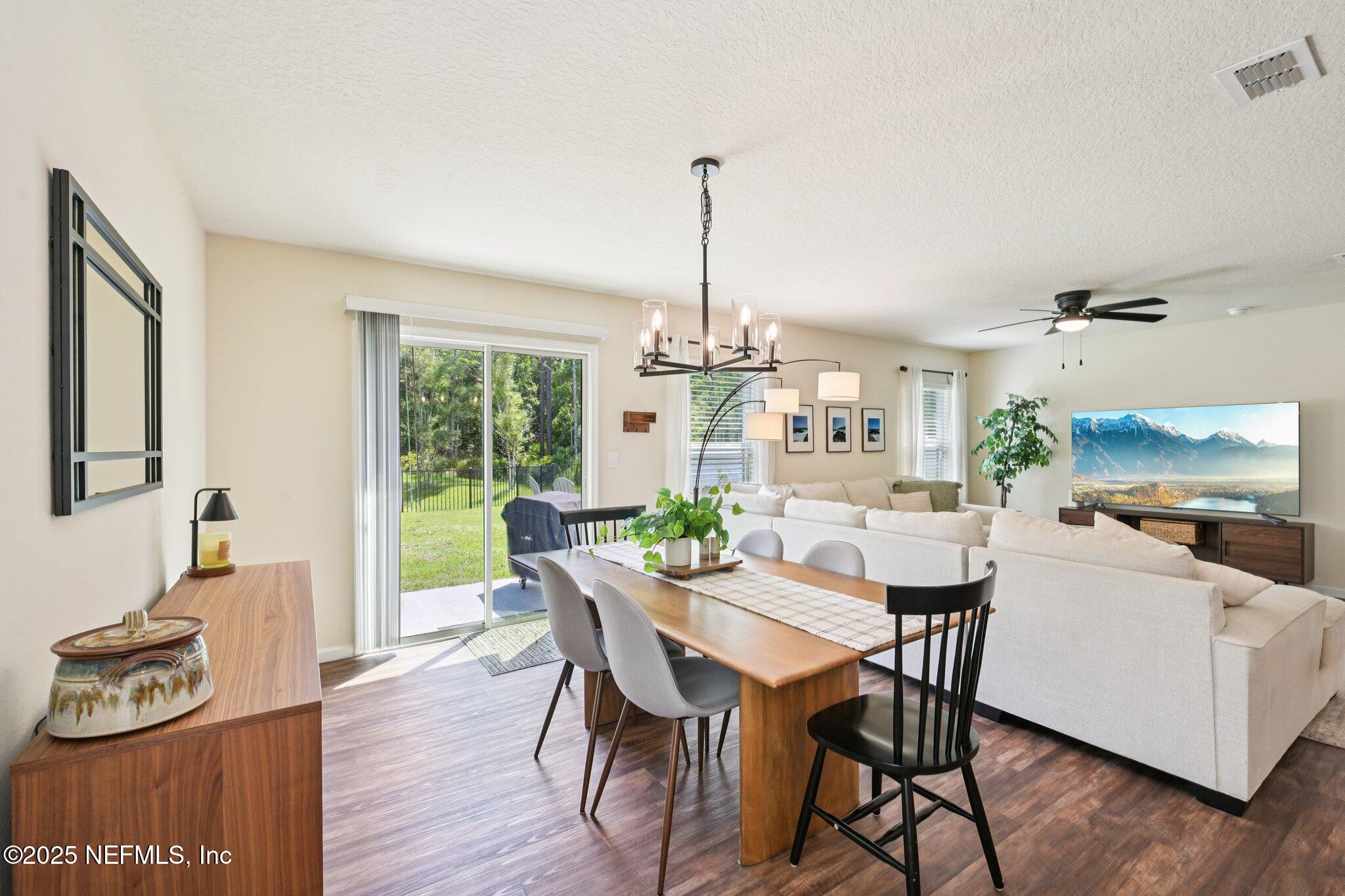 1143 Morgans Treasure Road St. Augustine, FL 32084 - Photo 8 of 39 a view of a dining room with furniture window and wooden floor