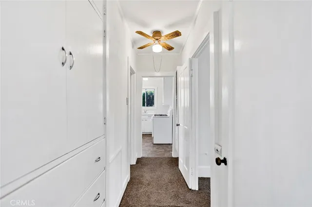 a view of a hallway with wooden shelves