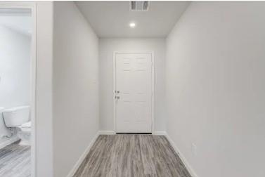 529 Don Lane Itasca, TX 76055 - Photo 10 of 15 a view of a hallway with wooden floor and a toilet
