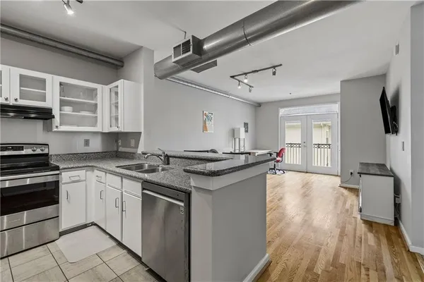 a kitchen with stainless steel appliances granite countertop a stove and a sink