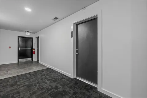 an empty room with wooden floor and closet