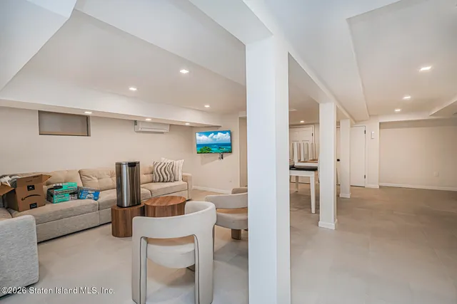 a living room with furniture and a view of kitchen