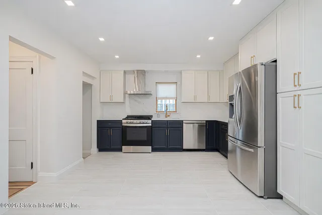 a kitchen with granite countertop a refrigerator and a sink