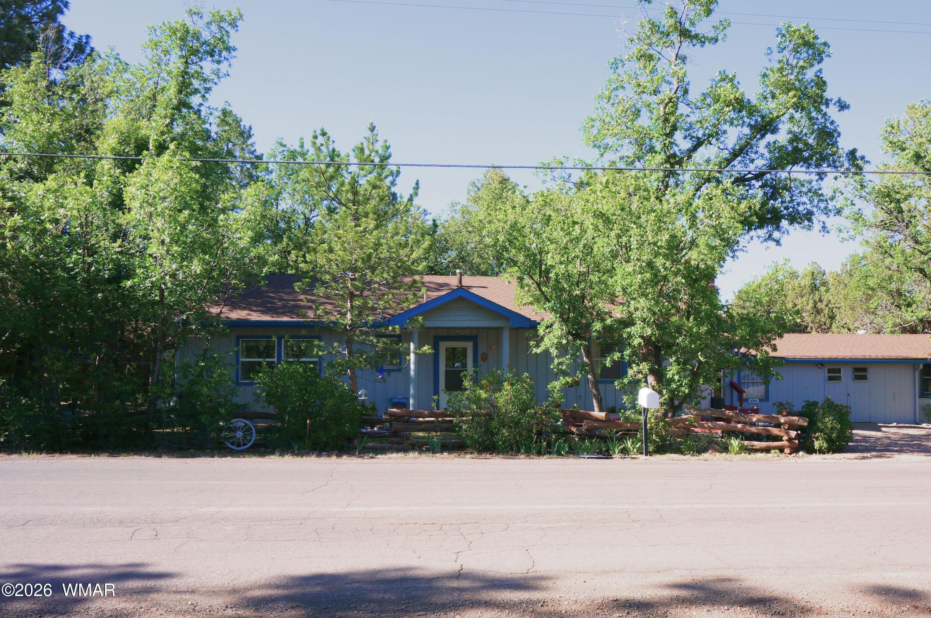 6066 Wagon Wheel Road Lakeside, AZ 85929 - Photo 2 of 32 a front view of a house with a yard and garage