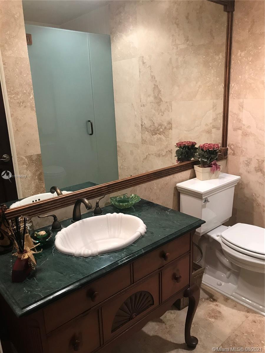 5278 Boca Marina Circle South Boca Raton, FL 33487 - Photo 13 of 37 a bathroom with a granite countertop sink and a mirror
