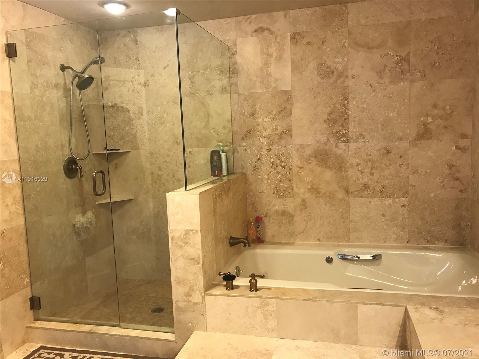 5278 Boca Marina Circle South Boca Raton, FL 33487 - Photo 14 of 37 a bathroom with a bathtub and a shower