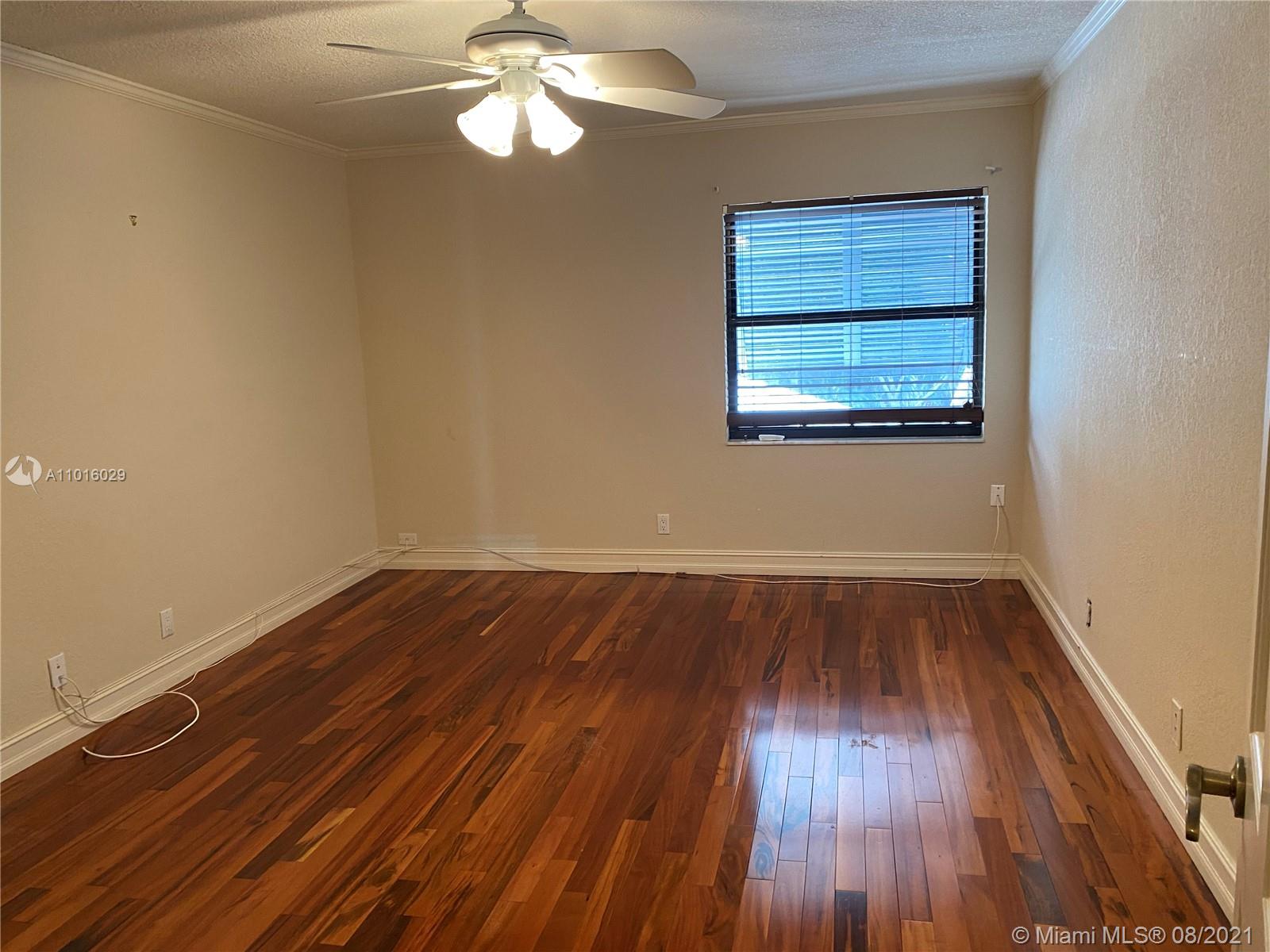 5278 Boca Marina Circle South Boca Raton, FL 33487 - Photo 18 of 37 wooden floor in an empty room with a window