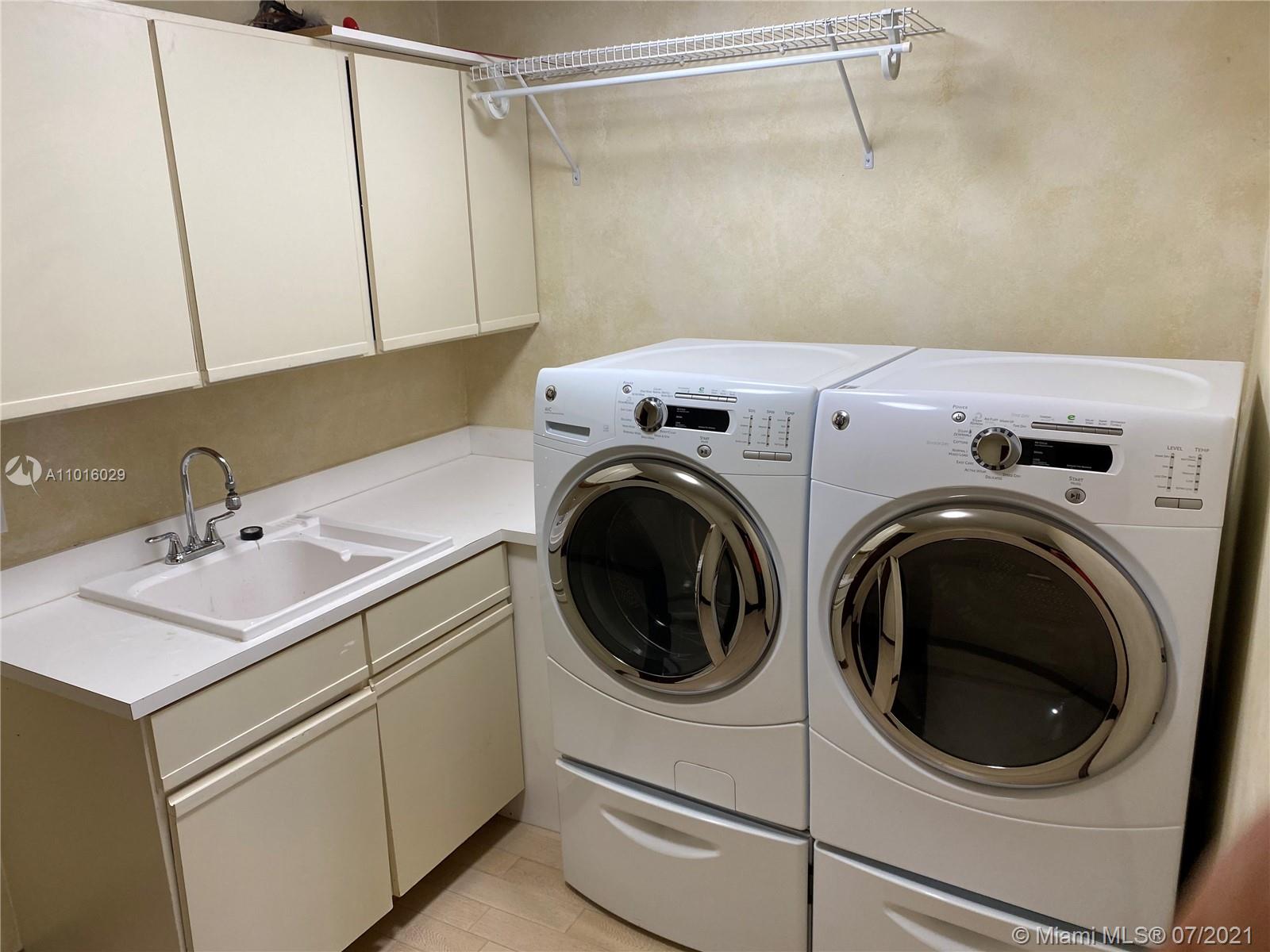 5278 Boca Marina Circle South Boca Raton, FL 33487 - Photo 20 of 37 a utility room with dryer and washer