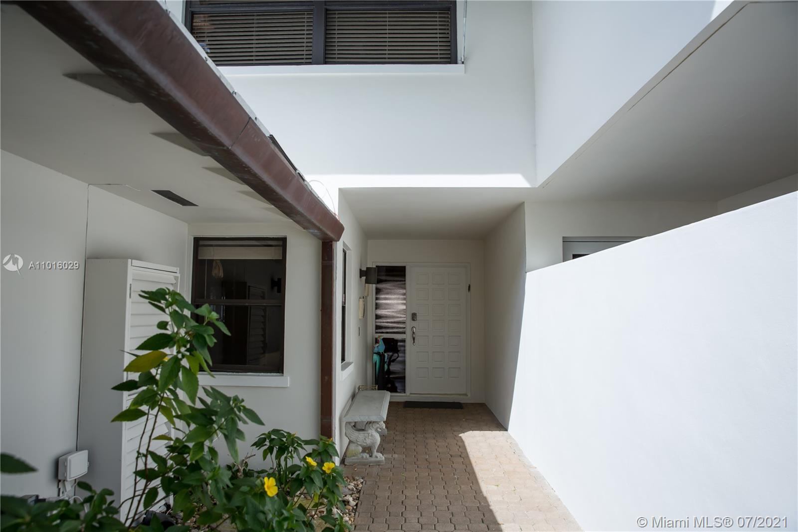 5278 Boca Marina Circle South Boca Raton, FL 33487 - Photo 3 of 37 a hallway with potted plants