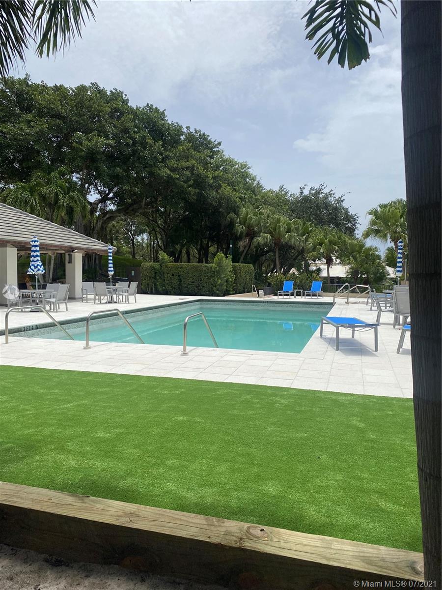 5278 Boca Marina Circle South Boca Raton, FL 33487 - Photo 36 of 37 a view of a swimming pool with a garden