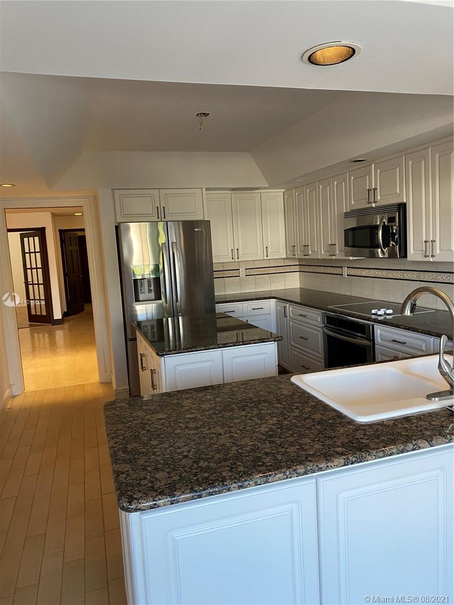 5278 Boca Marina Circle South Boca Raton, FL 33487 - Photo 7 of 37 a kitchen with stainless steel appliances granite countertop a sink a stove top oven a counter space and cabinets
