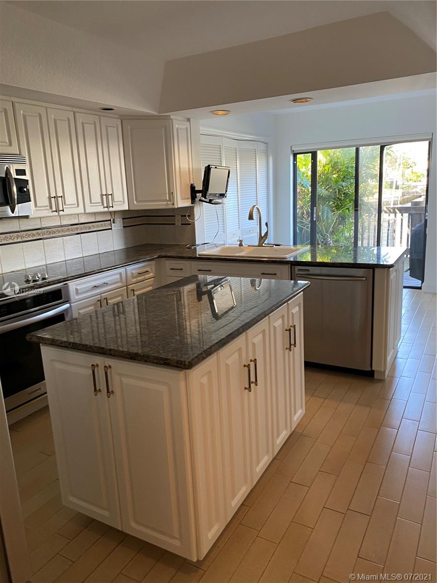 5278 Boca Marina Circle South Boca Raton, FL 33487 - Photo 8 of 37 a kitchen with granite countertop a sink and cabinets