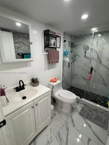 a bedroom with furniture and a wooden floor