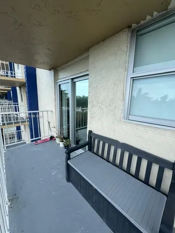 a view of a balcony with couches and city view
