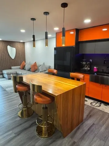 a dining room with wooden floor furniture and a fireplace