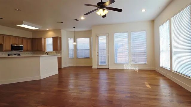 a view of a kitchen with a sink and dishwasher a oven with wooden floor