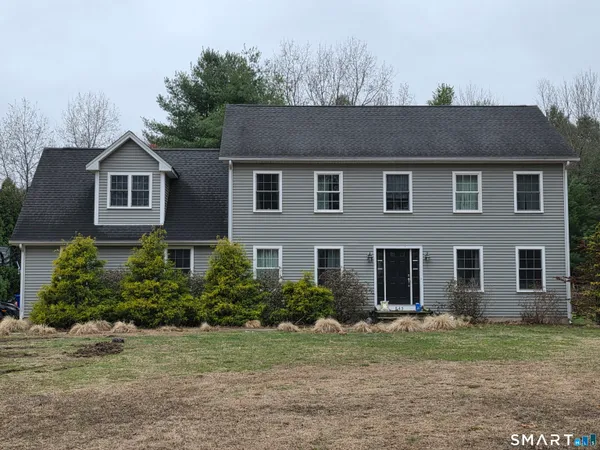 a front view of a house with a yard