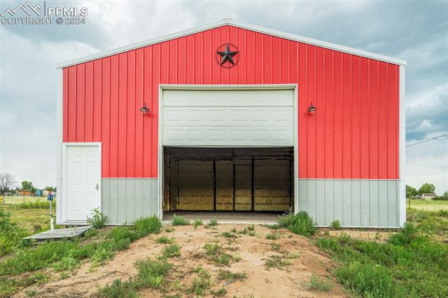 12550 Smith Road Peyton, CO 80831 - Photo 10 of 35 View of outbuilding featuring a garage